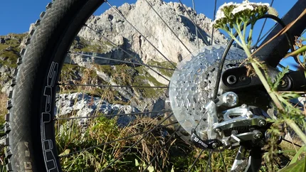 PANORAMIC TOUR SEISER ALM © Hotel Digon St. Ulrich Mountain bike rear wheel with mountain and blue sky background