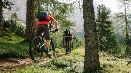 THROUGH THE MILL VALLEY © Szymon Bike Two cyclists riding on a mountain trail through a forest