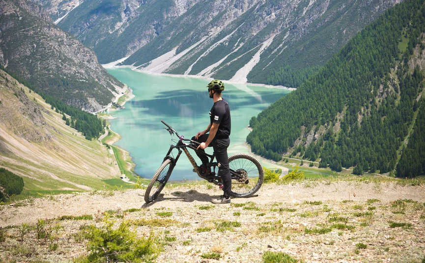 Mountain bike holidays in Livigno © APT Livigno Cyclist overlooking mountain lake in alpine scenery