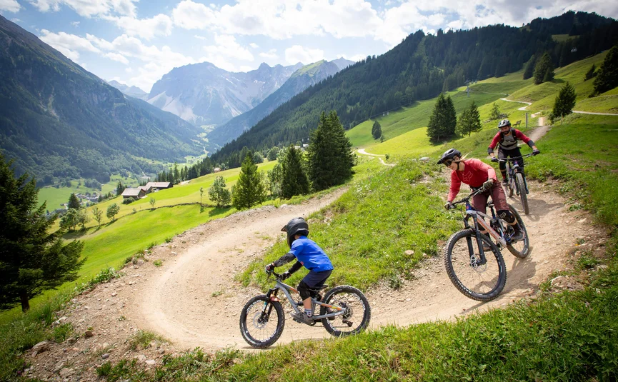 Mountain bike holiday in Brandnertal © Michael Marte - Bikepark Brandnertal Three mountain bikers riding on a mountain trail in the Alps