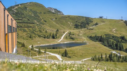 Zauchbach Tour © Jonas Lehmann Mountain landscape with lake, hiking trails and building under clear sky