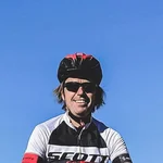 Mountain Bike Holidays © Hotel Montanara Fahrradfahrer auf felsigem Berggipfel mit Skulptur und Bergen im Hintergrund