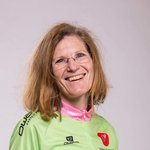 Mountain Bike Holidays © WOM Medien Lächelnde Frau in Mountainbike-Trikot und Jeans vor hellem Hintergrund