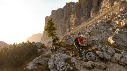 Cir Trail © David Karg Two mountain bikers riding on rocky mountain trail in the Alps