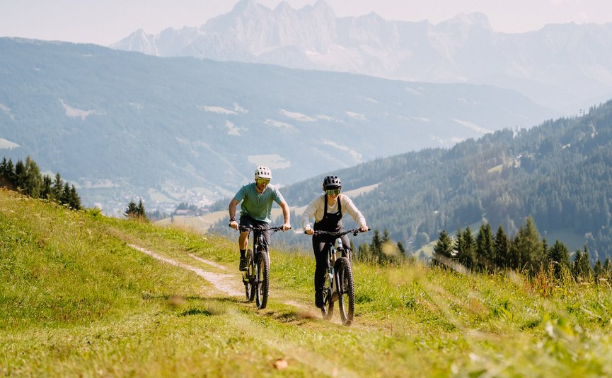 Mountain bike holidays in Flachau © Flachau Tourismus - Simon Reisinger Two people mountain biking on a grassy mountain trail