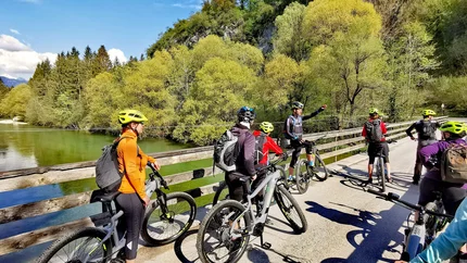 POKLJUKA - TRIGLAV NATIONAL PARK © Ribno Alpine Resort - Katarina Strgar Group of cyclists with helmets on a bridge in a natural setting