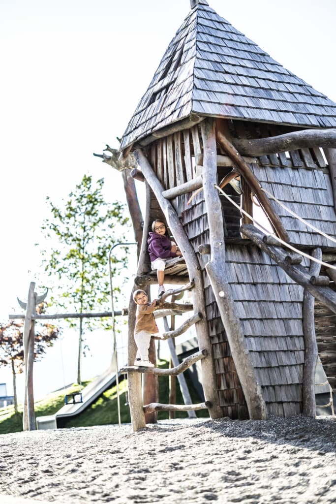 active week Children climbing on a wooden treehouse in a playground