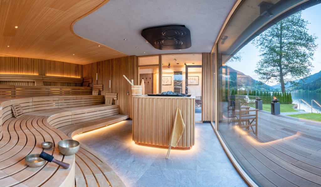 Brennseehof Sauna days Modern sauna interior with wooden benches and lake and mountain view